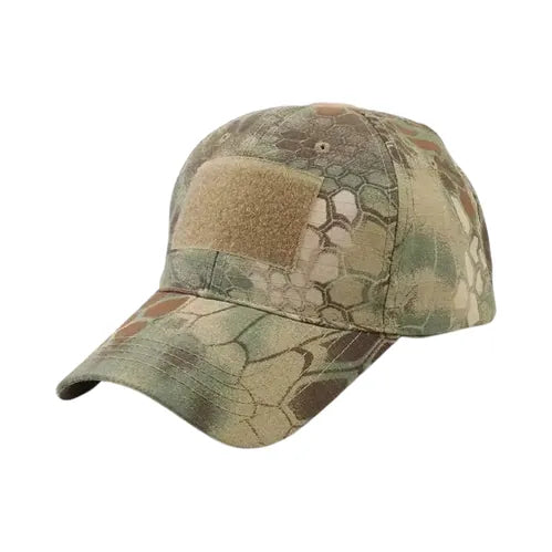 Casquette tactique camouflage hexagonal en coton ripstop, coloris vert et brun, avec scratch velcro sur le front, idéale pour camping, bushcraft et survie.