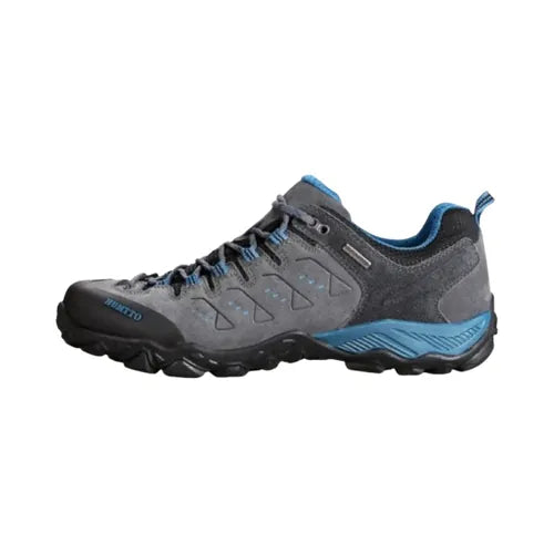 Chaussure de randonnée Humtto pour homme, coloris gris et bleu, vue latérale, semelle Vibram antidérapante et tige résistante, idéale pour trekking et marche en montagne.